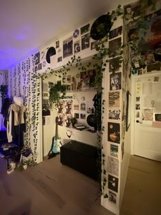 a living room filled with furniture and lots of pictures on the wall next to a window