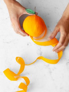 someone is peeling an orange with tape