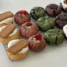 there are many cookies and pastries on the cooling rack