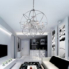 a living room filled with white furniture and a chandelier hanging from the ceiling