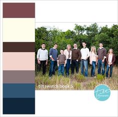 a group of people standing next to each other in a field with trees behind them