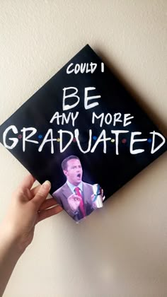 someone holding up a graduation cap that says, could i be any more graduate?