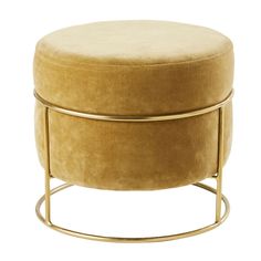 a round ottoman with gold metal frame and velvet upholstered cushion on the top