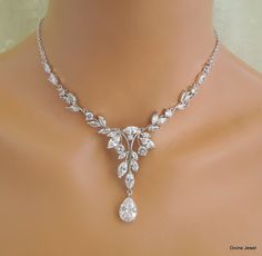 This beautiful cubic zirconia set comes with necklace and earrings.   This crystal jewelry set comes with necklace and earrings. It has the perfect amount of sparkle for your Old Hollywood Glam, vintage wedding, formal event, special occasion. Necklace is available from 14" to 22" long.  Focal point measures approximately 5 3/4" wide by 2 1/4" long including the teardrop.  Finished with rhodium plated chain and a lobster claw closure. It comes with a 2" extender chain for additional length. Chandelier earrings are about 1 7/8" long from top to bottom.  Perfect for a classy bride or any special occasion! Necklace can be extended up to 18" long without extra charge if specified at the time of ordering. Matching bracelet, https://www.etsy.com/listing/644578685/crystal-bracelet-cubic-zirconia- Statement Necklace Wedding, Bridal Earrings Studs, Bridal Earrings Chandelier, Wedding Jewelry Set, Bridal Necklace Set, Old Hollywood Glam, Bridal Jewelry Set, Crystal Jewelry Sets, Wedding Formal