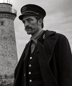 a man standing in front of a light house