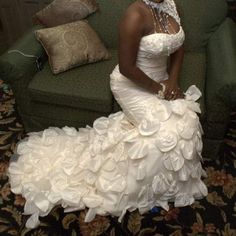 a woman in a wedding dress sitting on a couch