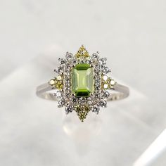 Beautiful Estate Style Solid Sterling Silver Setting With Simulated White And Yellow Diamonds Natural 7x5mm (1ct) Emerald Cut Peridot Center Stone. Peridot Wedding Ring, Emerald Cut Peridot Ring For May Birthstone, Emerald Cut Peridot Gemstone Jewelry, Emerald Cut Peridot Ring In Green, Green Peridot Rings With Brilliant Cut, Lime Green Peridot Rings Fine Jewelry, Peridot Engagement Rings, Costume Rings, Rose Gold Crystal