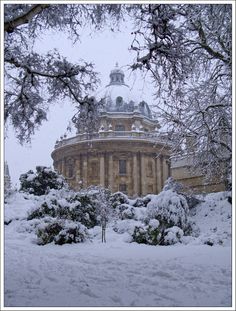 the building is surrounded by snow and trees