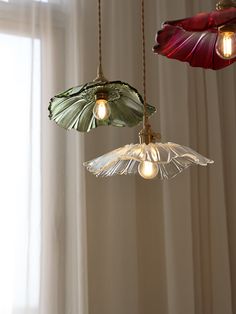 three lights hanging from a ceiling in a room