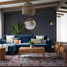 a living room with blue couches and wooden tables in it's center area