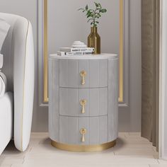 a white and gold side table next to a bed with a plant on top of it