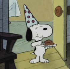 a cartoon dog wearing a party hat and holding a plate