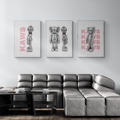 a living room filled with furniture and two pictures on the wall above it's couch