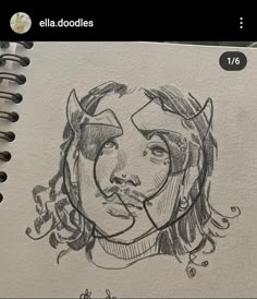 a drawing of a woman's face on a piece of paper