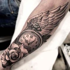 a man's arm with a clock and rose tattoo on it