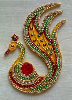 an intricately designed necklace with red, green and yellow beads on the bottom side