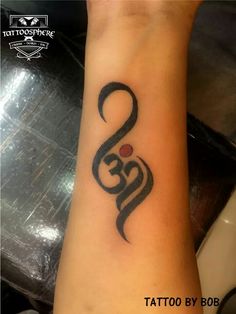 a tattoo on the wrist with an omen symbol