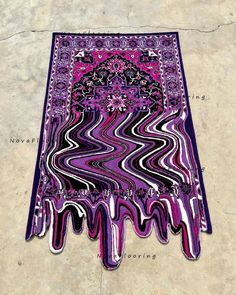 a purple and black area rug on the ground