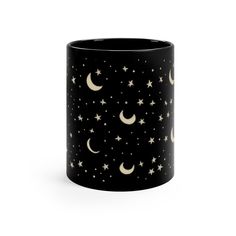 a black mug with stars and crescents on it