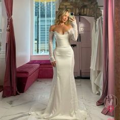 a woman in a wedding dress taking a selfie