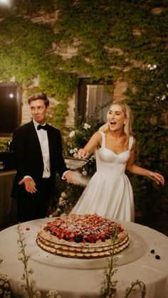 a bride and groom cutting their wedding cake