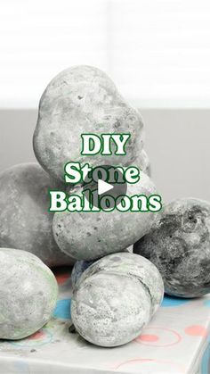 some rocks are stacked on top of each other with the words diy stone balloons