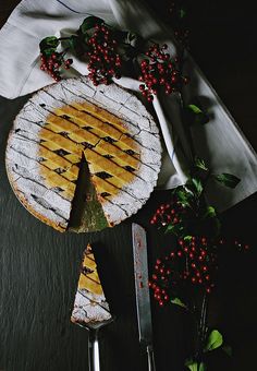 a piece of pie sitting on top of a table next to a knife and fork