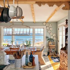 an open kitchen and dining room area overlooking the water