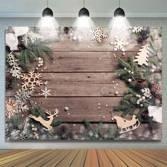 a wooden wall with christmas decorations and deers on the wood planked floor in front of it