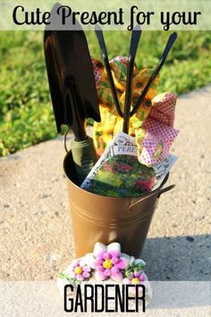 gardening utensils in a flower pot on the side of a road with flowers