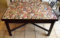 a coffee table with many different colored buttons on it and two chairs in the background