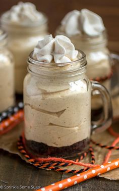 a glass jar filled with whipped cream on top of a table