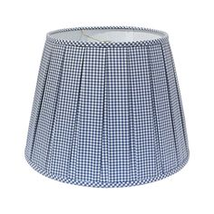 a blue and white gingham lampshade with pleated fabric on the bottom