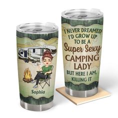 two travel mugs with an image of a woman sitting in front of a camper