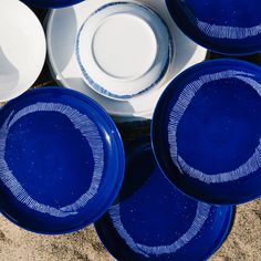 blue and white plates sitting on top of each other in the middle of a circle