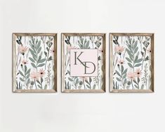 three framed art pieces with pink flowers and green leaves on the wall next to each other