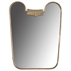 a mirror that has some gold trim around it