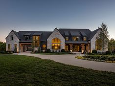 a large house with lots of windows and landscaping