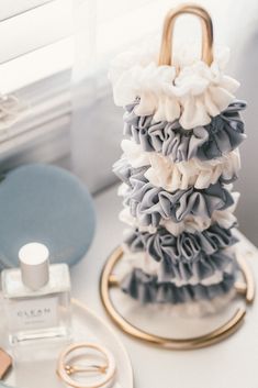 a stack of ruffles sitting on top of a table next to a bottle of perfume