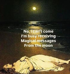 a woman laying on the beach in front of the ocean at night, with a full moon above her