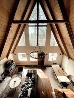 an aerial view of a living room and dining area in a house with high vaulted ceilings