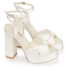 These ivory block heels hold our signature padding on the insole, elegantly knotted silk on the toe, and secure ankle straps at the back. Serafina is the complete package for a confident and sophisticated look on your special day. Reach new heights in these fashion forward 5-inch wedding shoes. Reviews say: fit true to size. However, please size up if you run in between sizes Heel Height: 5 inches heels with 1 inch platform Colour: Ivory Handmade Upper Material: Silk Lining Material: Leather lin Bella Belle Shoes, Belle Shoes, Freetime Activities, Ivory Heels, Perfect Wedding Shoes, Cute Shoes Heels, Bridal Sandals, Bridal Heels