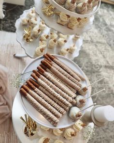 three tiered trays filled with sandwiches and desserts on top of each other