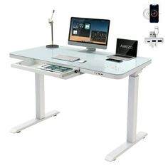 a computer desk with two computers on it