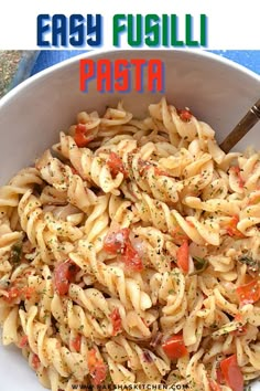 a pasta dish with tomatoes and herbs in a white bowl