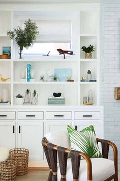 a living room filled with furniture and lots of white shelves covered in plants on top of bookshelves