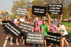 a group of people holding up signs in the street