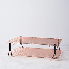 two tiered metal shelf with black handles