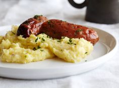 a white plate topped with scrambled eggs and sausage