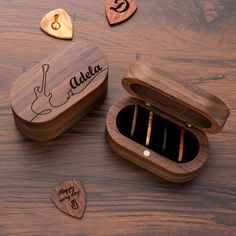 wooden music box with personalized musical instruments in it on top of a wood table